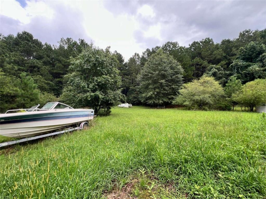 1383 Sims Road Southeast Statham, GA 30666 - Photo 4 of 9 a view of a lake with a yard