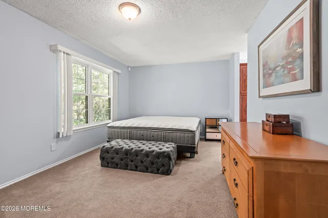 a bedroom with bed and window