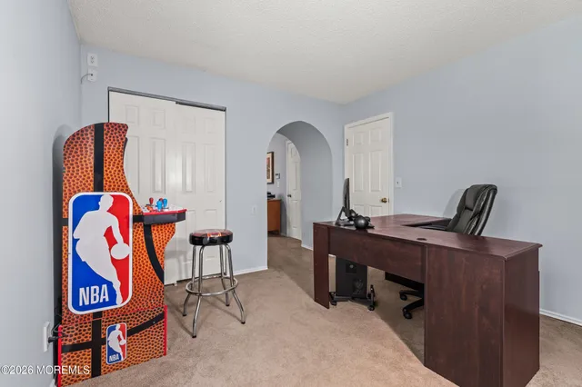 a view of a workspace with furniture and a window