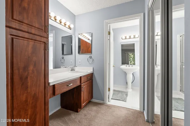 a bathroom with a sink a mirror and a vanity