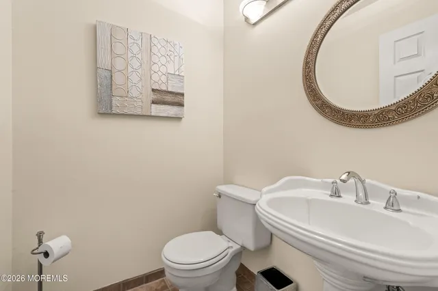 a white toilet sitting next to a bathroom sink