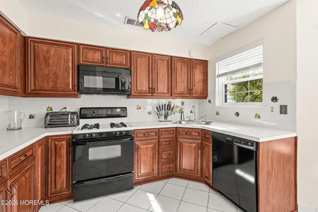 a kitchen with a stove sink and microwave