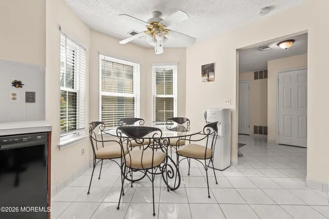 a view of a dining room with furniture and a chandelier