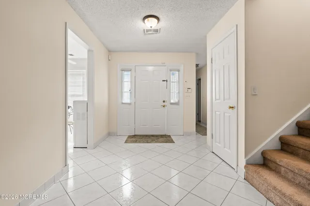 a view of a livingroom with an empty space and a window