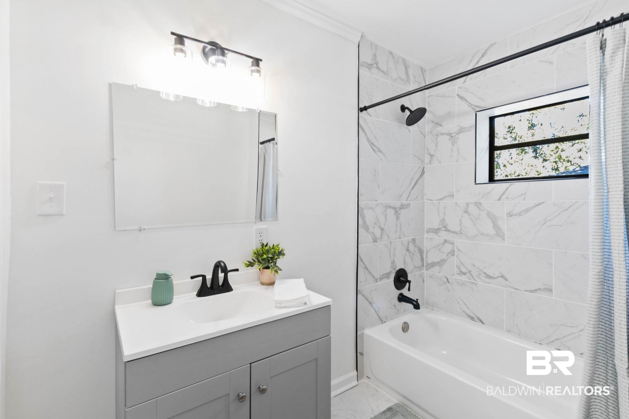 618 Pine Street Saraland, AL 36571 - Photo 19 of 41 Bathroom with shower / bathtub combination with curtain, vanity, and light marble finish flooring