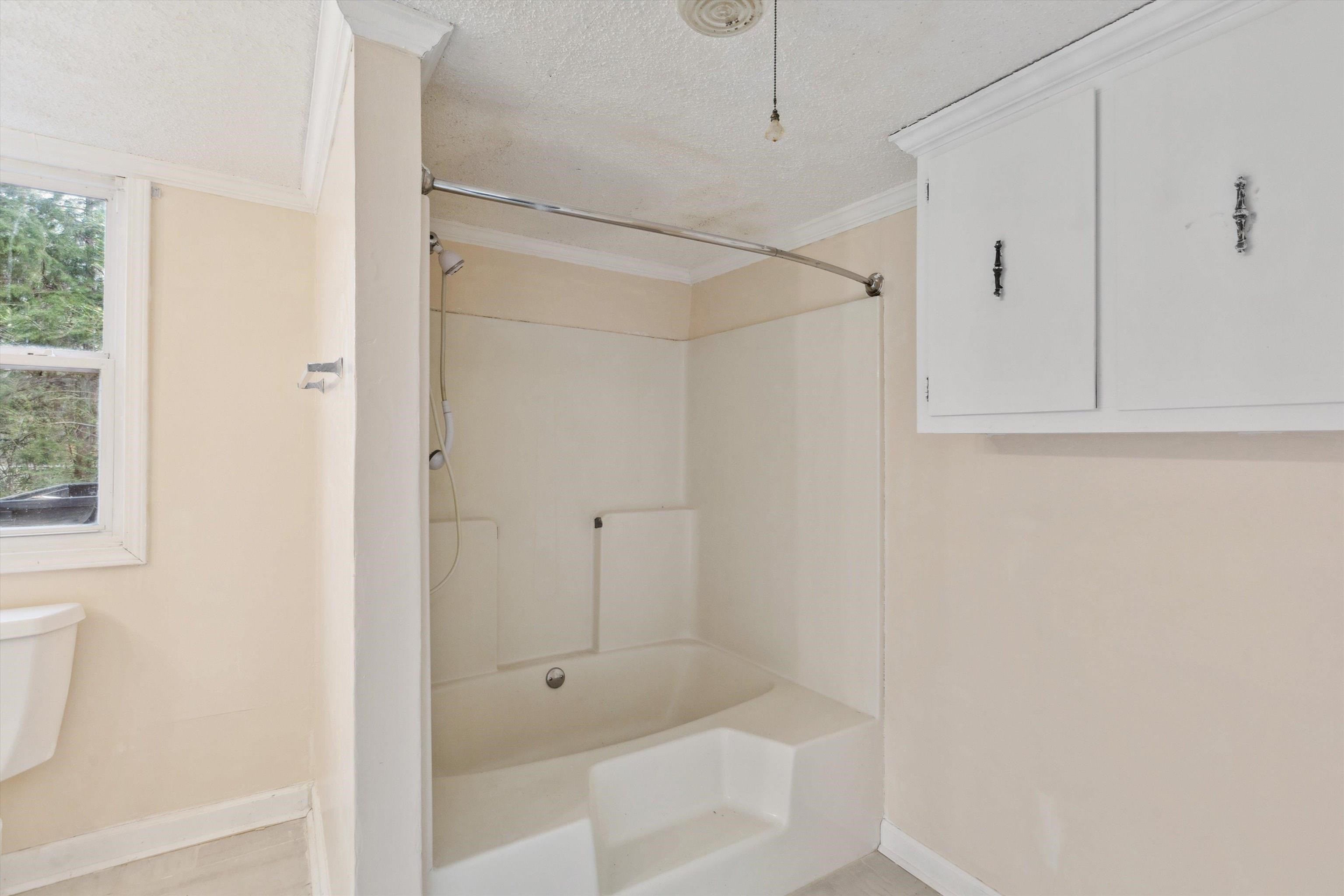 8457 East Kerrville Rosemark Road Millington, TN 38053 - Photo 19 of 25 Full bathroom featuring shower / bath combination, ornamental molding, and a textured ceiling