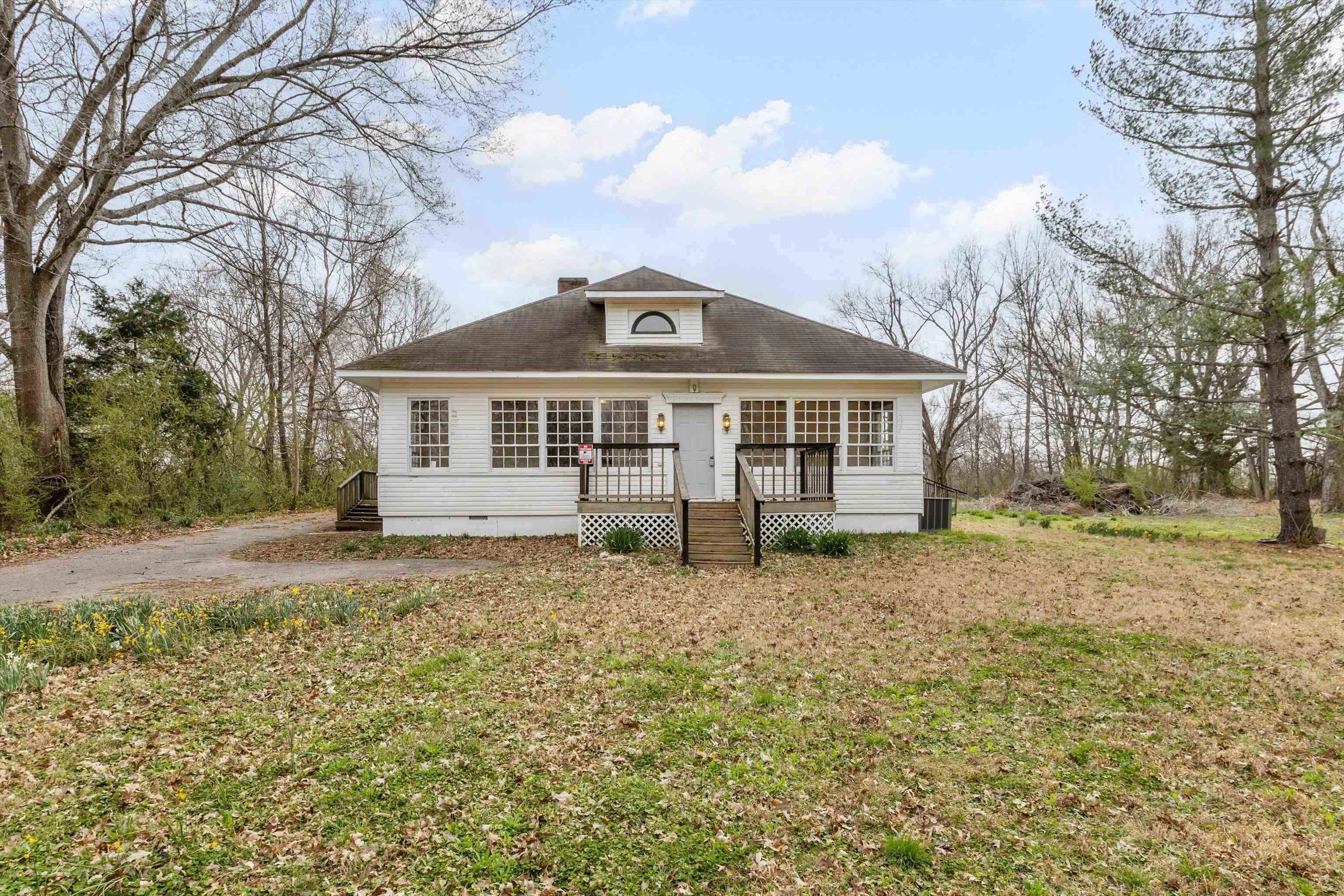 8457 East Kerrville Rosemark Road Millington, TN 38053 - Photo 2 of 25 Bungalow featuring crawl space, a front lawn, a chimney, and a deck