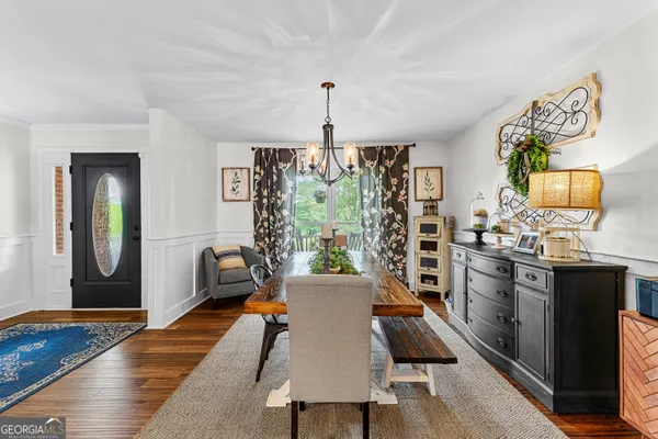 a view of a dining room with furniture and wooden floor