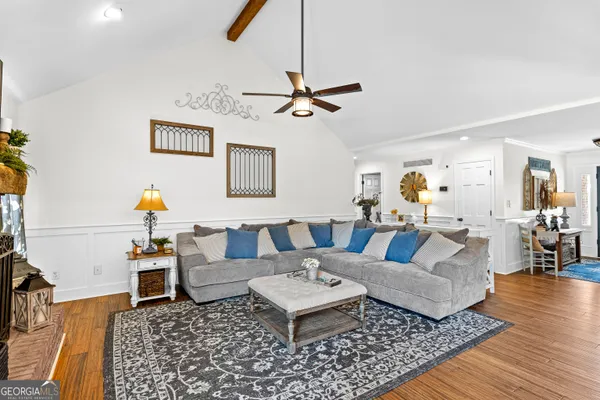 a large kitchen with stainless steel appliances granite countertop a lot of counter space and a wooden floors