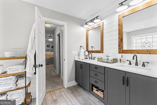 a bathroom with a sink a toilet and mirror
