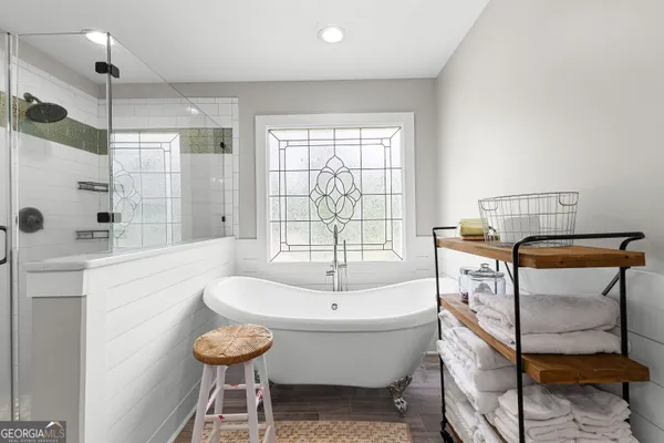a spacious bathroom with a sink a mirror and a shower