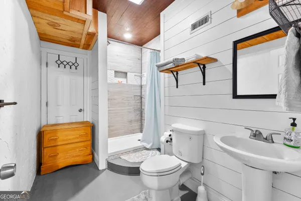 a white toilet sitting next to a bathroom sink