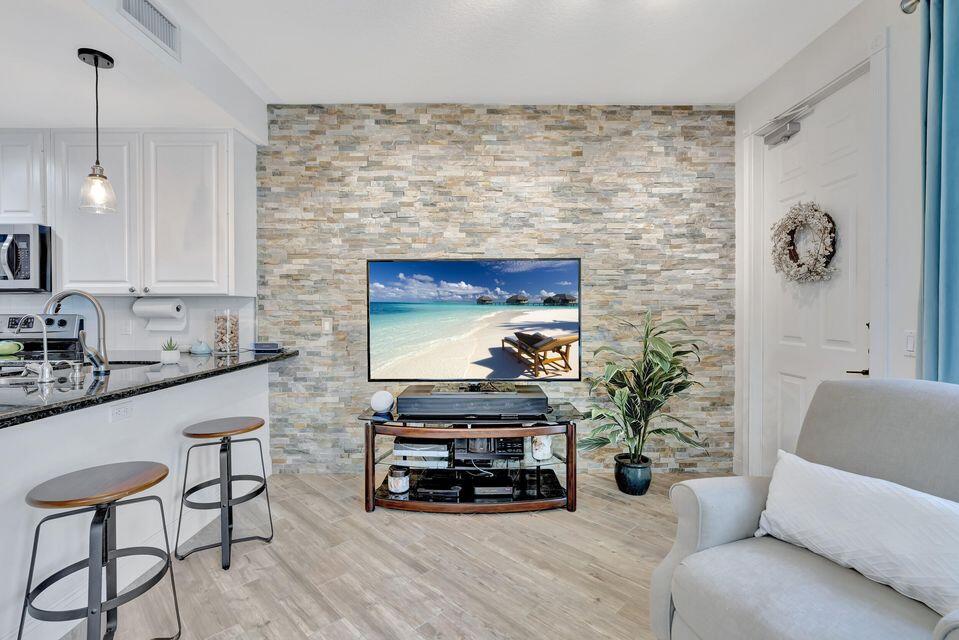 180 Freeport Drive Jupiter, FL 33458 - Photo 11 of 58 a living room with furniture and a fireplace