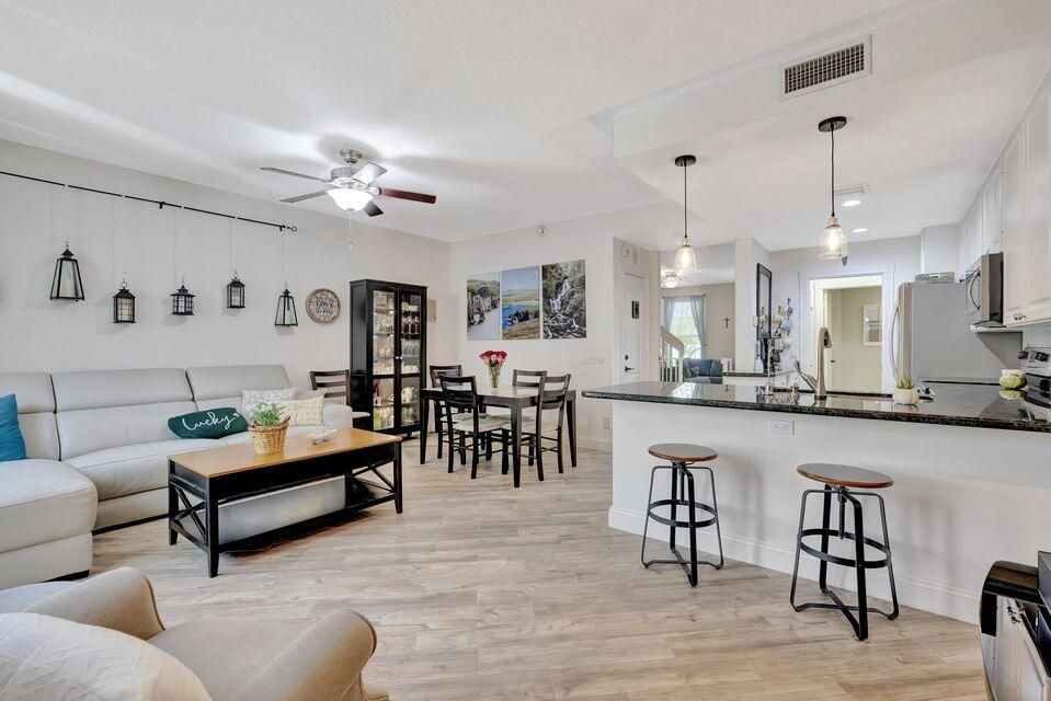 180 Freeport Drive Jupiter, FL 33458 - Photo 12 of 58 a living room with furniture and kitchen view