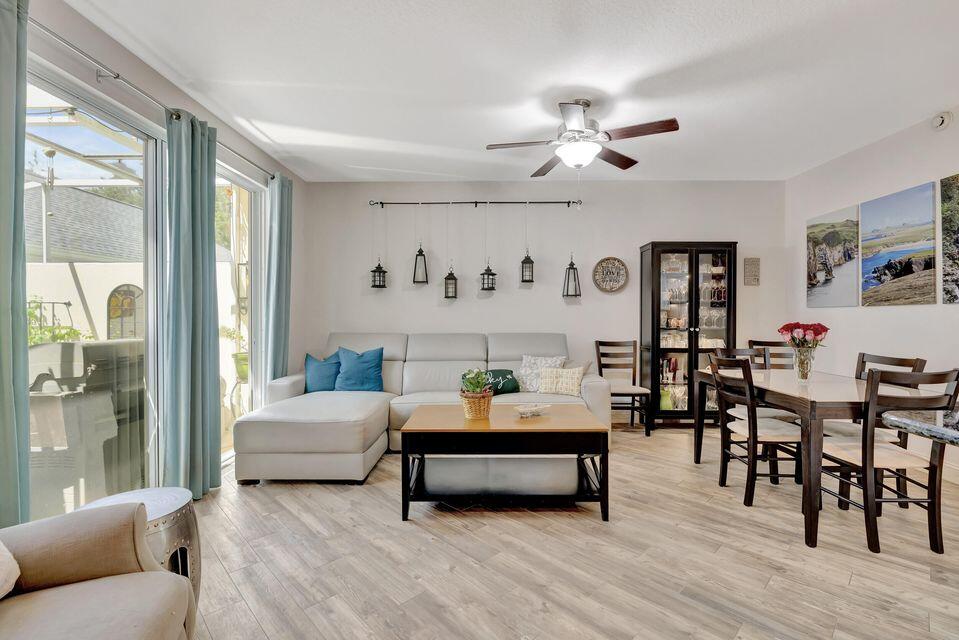 180 Freeport Drive Jupiter, FL 33458 - Photo 13 of 58 a bedroom with a bed and a chandelier