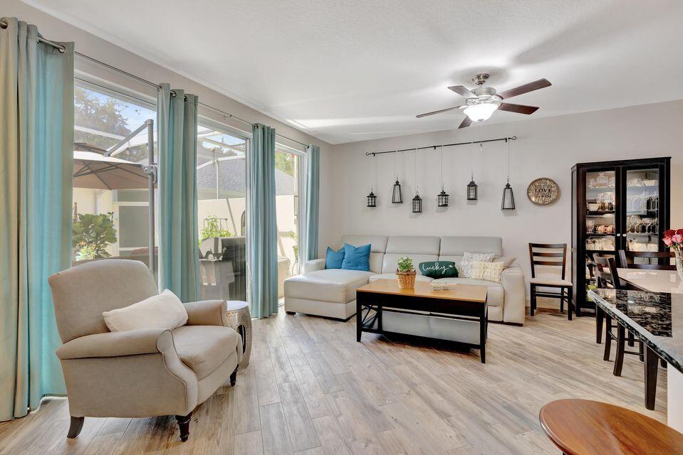 180 Freeport Drive Jupiter, FL 33458 - Photo 14 of 58 a living room with furniture and wooden floor