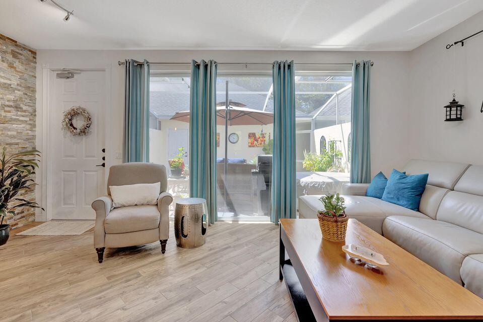 180 Freeport Drive Jupiter, FL 33458 - Photo 16 of 58 a living room with furniture and wooden floor