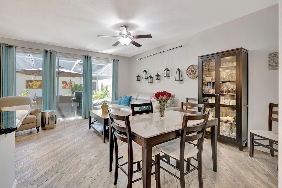 180 Freeport Drive Jupiter, FL 33458 - Photo 19 of 58 a view of a dining room with furniture window and wooden floor