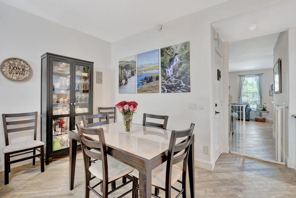 180 Freeport Drive Jupiter, FL 33458 - Photo 20 of 58 a view of a dining room with furniture and wooden floor