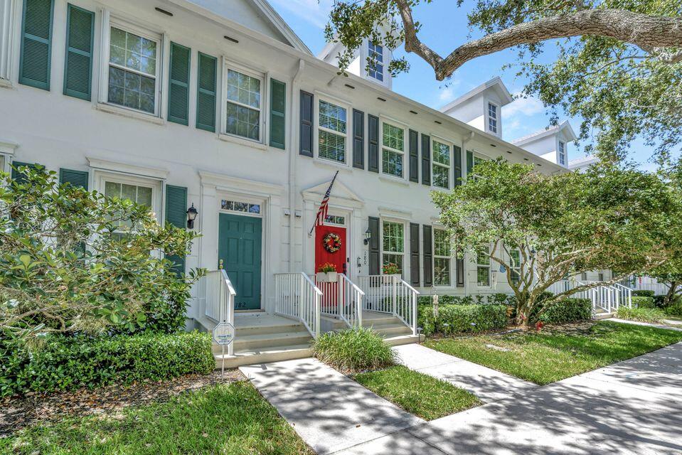 180 Freeport Drive Jupiter, FL 33458 - Photo 2 of 58 a front view of a house with garden
