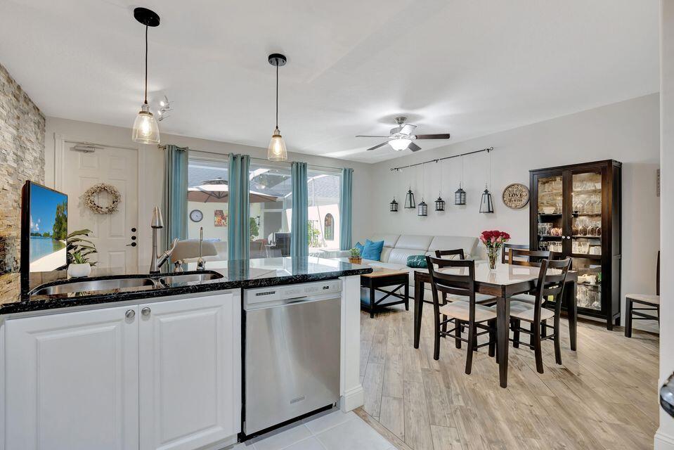 180 Freeport Drive Jupiter, FL 33458 - Photo 25 of 58 a view of a dining room and livingroom with furniture wooden floor a chandelier