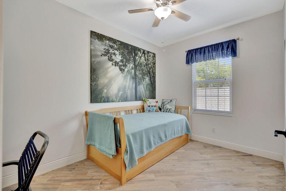 180 Freeport Drive Jupiter, FL 33458 - Photo 28 of 58 a bedroom with a bed and a window