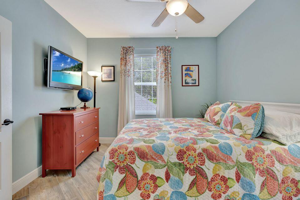 180 Freeport Drive Jupiter, FL 33458 - Photo 32 of 58 a bedroom with a bed and a dresser