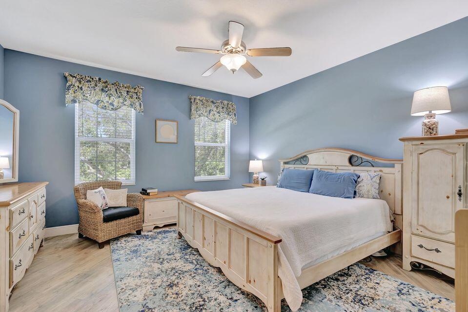 180 Freeport Drive Jupiter, FL 33458 - Photo 36 of 58 a bedroom with a bed and a chandelier