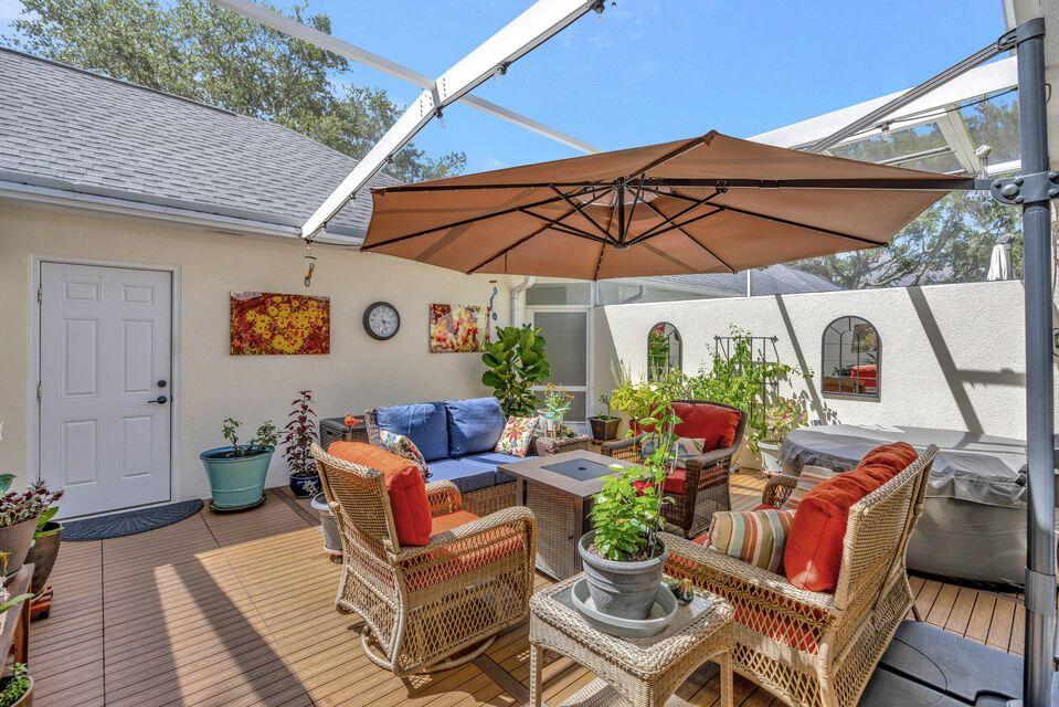 180 Freeport Drive Jupiter, FL 33458 - Photo 44 of 58 a view of patio with a table and chairs under an umbrella