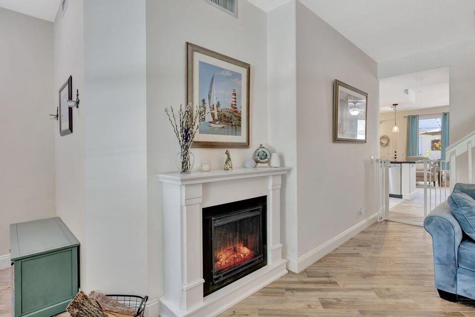 180 Freeport Drive Jupiter, FL 33458 - Photo 5 of 58 a living room with furniture and a fireplace