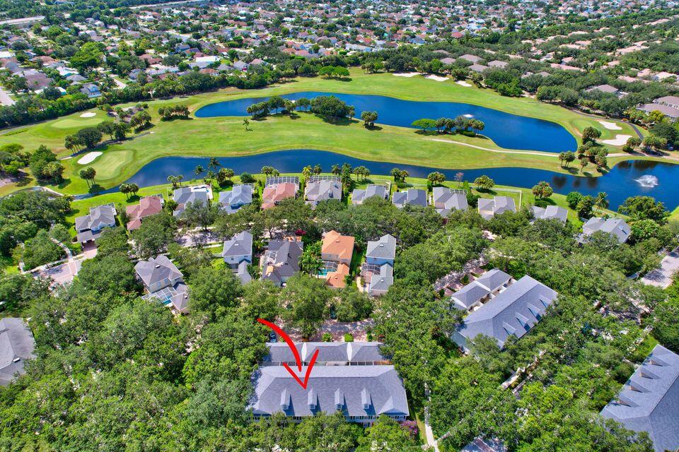 180 Freeport Drive Jupiter, FL 33458 - Photo 56 of 58 an aerial view of a house with a garden and lake view