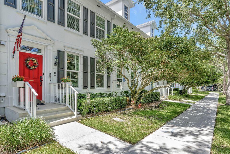 180 Freeport Drive Jupiter, FL 33458 - Photo 58 of 58 a view of a brick house with a yard and plants
