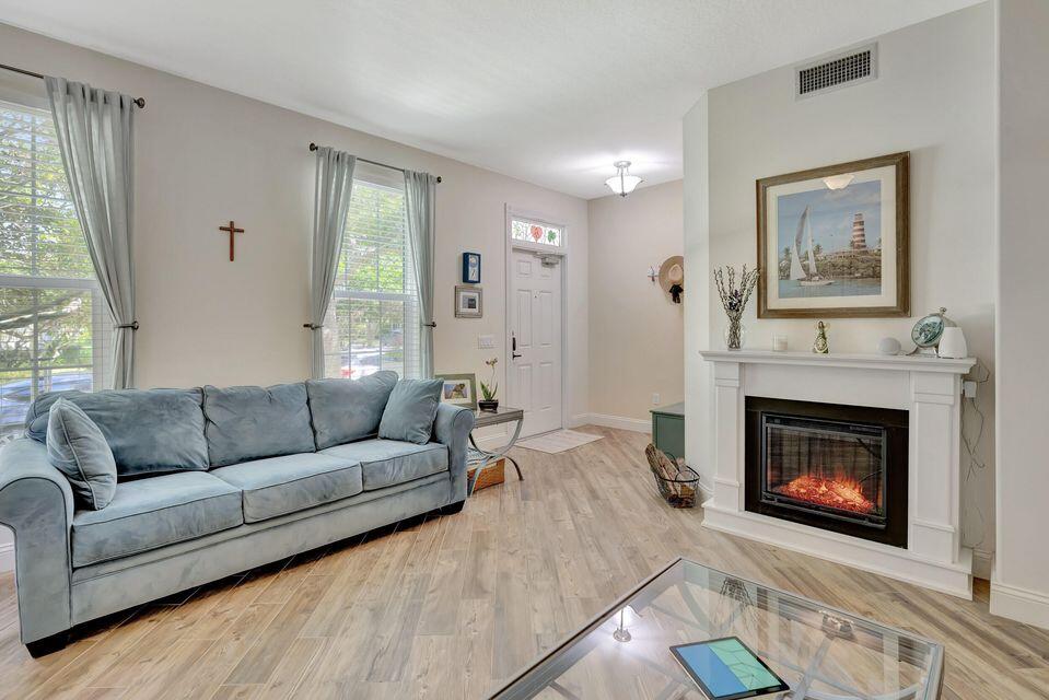180 Freeport Drive Jupiter, FL 33458 - Photo 7 of 58 a living room with furniture and a fireplace
