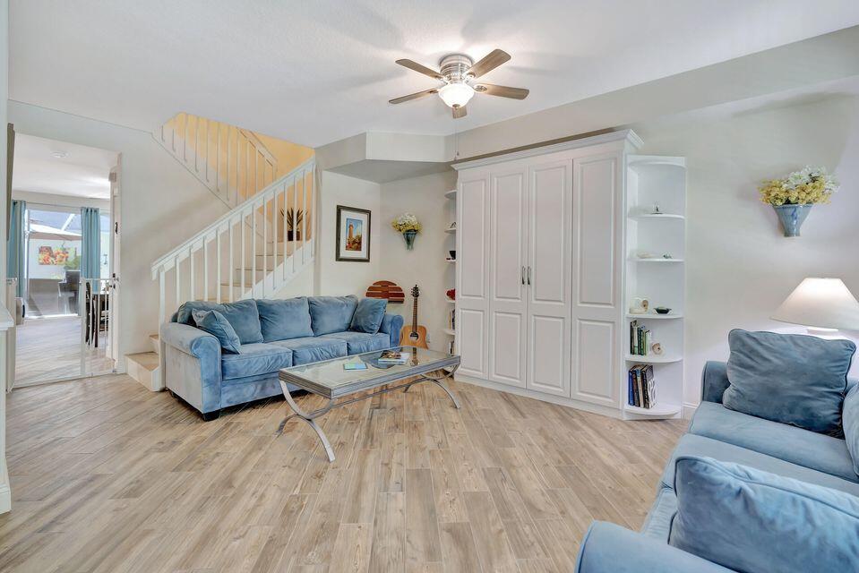 180 Freeport Drive Jupiter, FL 33458 - Photo 9 of 58 a living room with furniture and a wooden floor