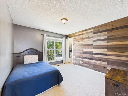 a bedroom with a large bed and a window