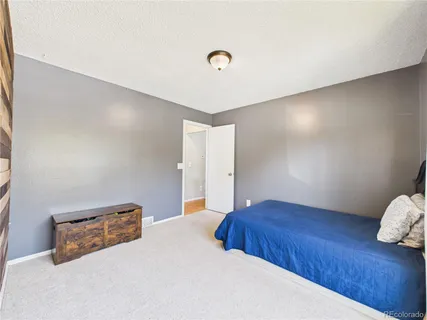 a bedroom with a bed and a lamp with wooden floor