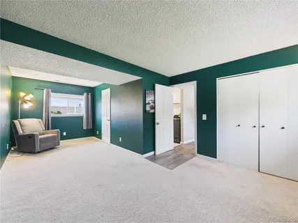 a large bedroom with a large bed and lamp