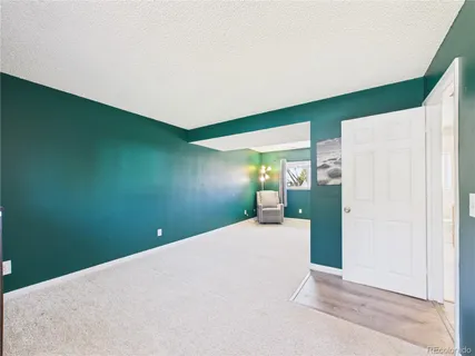 a view of a livingroom with a refrigerator