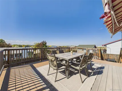 a view of a roof deck with table and chairs