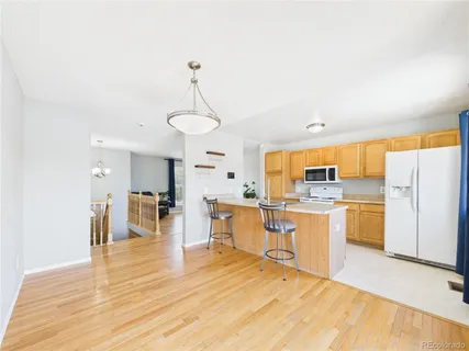 a large kitchen with kitchen island a sink a center island stainless steel appliances and cabinets