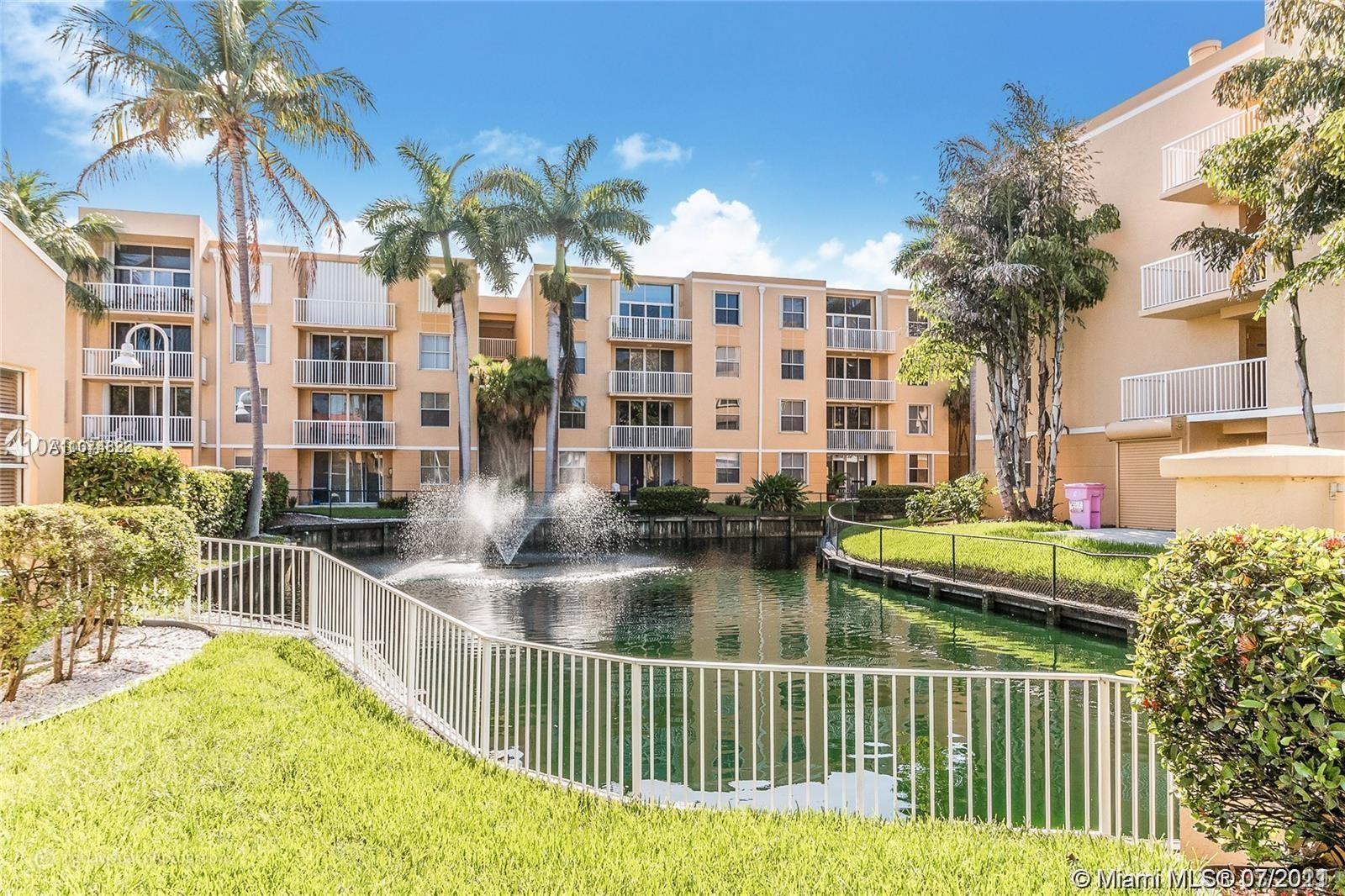 1450 Southeast 3rd Avenue, Unit 107 Dania Beach, FL 33004 - Photo 1 of 15 a front view of a house with swimming pool