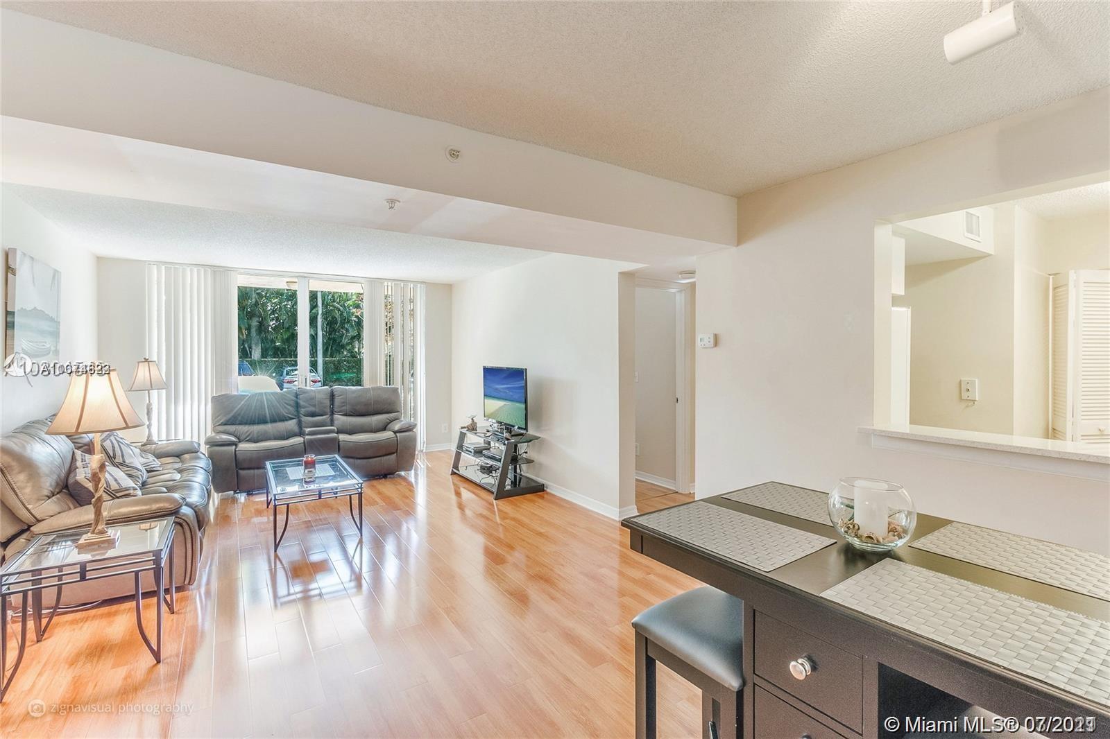 1450 Southeast 3rd Avenue, Unit 107 Dania Beach, FL 33004 - Photo 3 of 15 a view of a living room and dining room