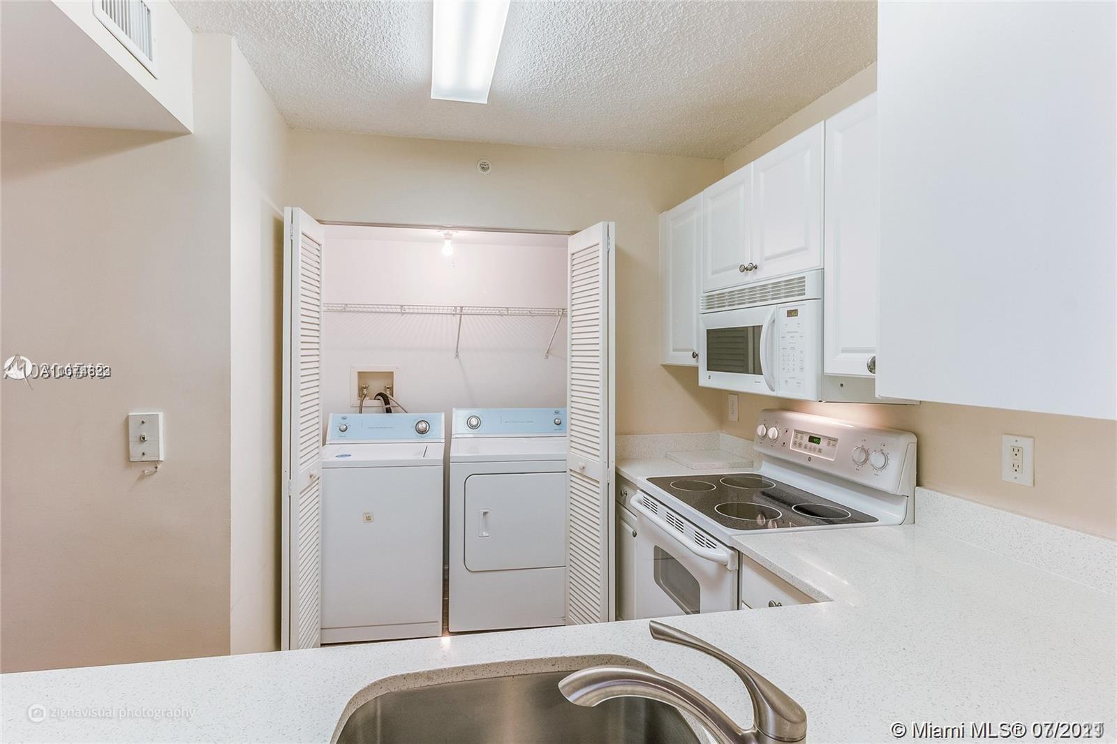 1450 Southeast 3rd Avenue, Unit 107 Dania Beach, FL 33004 - Photo 5 of 15 a room with storage and utility