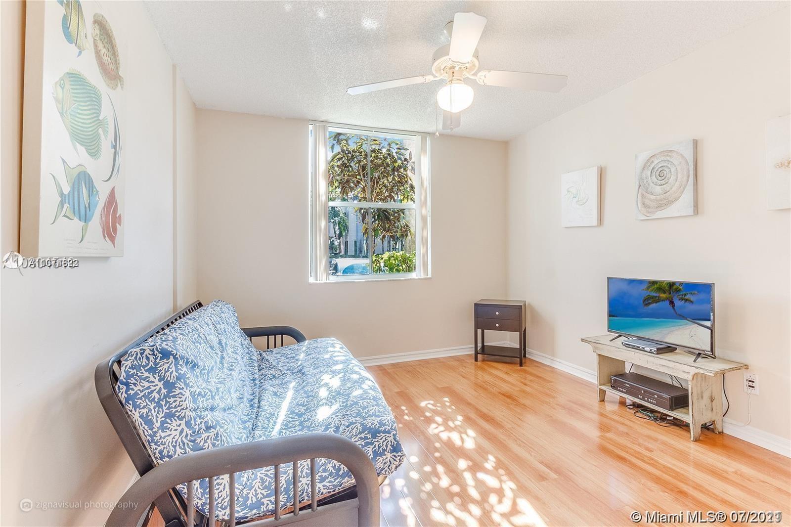 1450 Southeast 3rd Avenue, Unit 107 Dania Beach, FL 33004 - Photo 9 of 15 a bedroom with furniture and a window