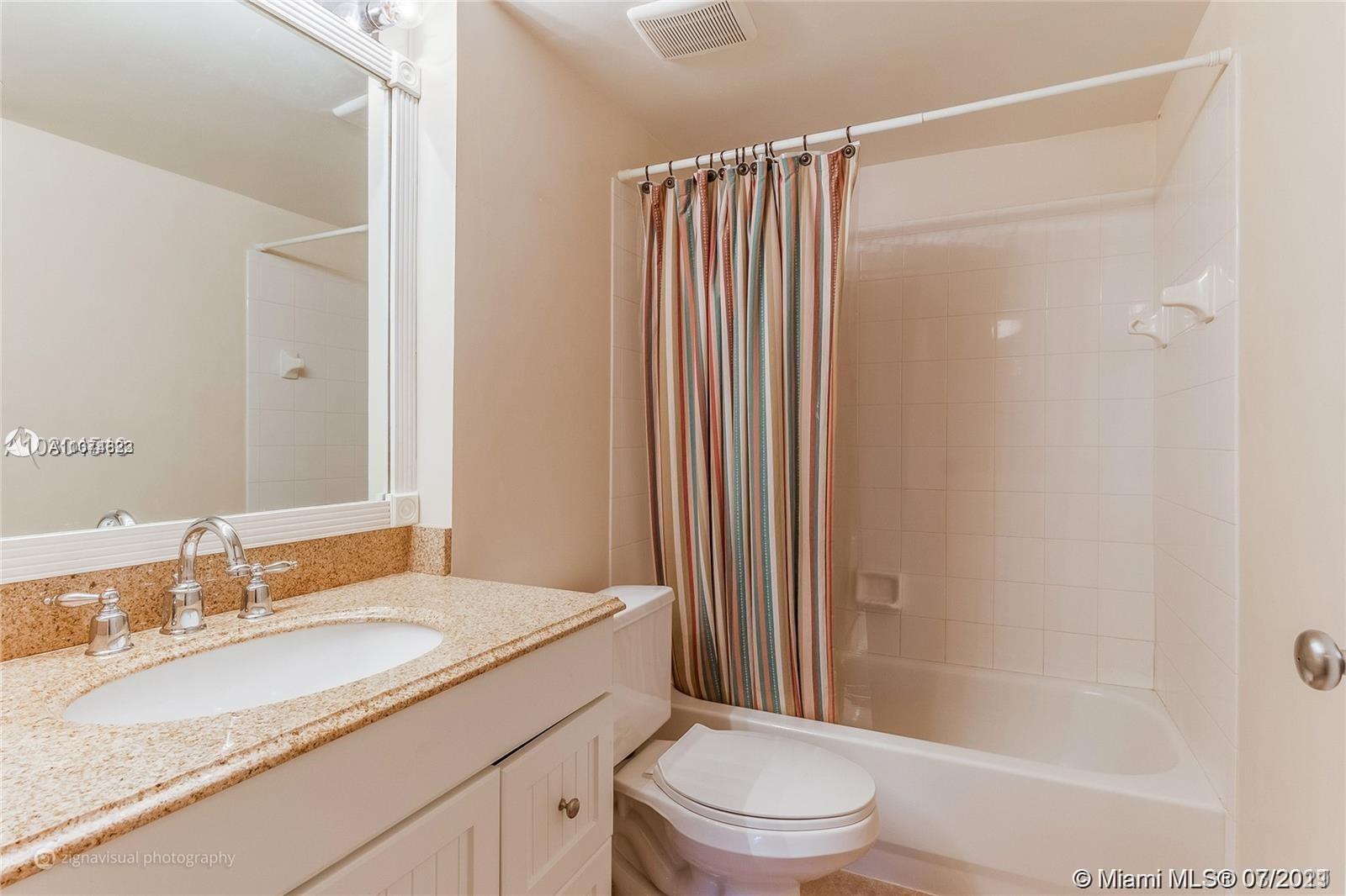 1450 Southeast 3rd Avenue, Unit 107 Dania Beach, FL 33004 - Photo 10 of 15 a bathroom with a granite countertop sink toilet and shower