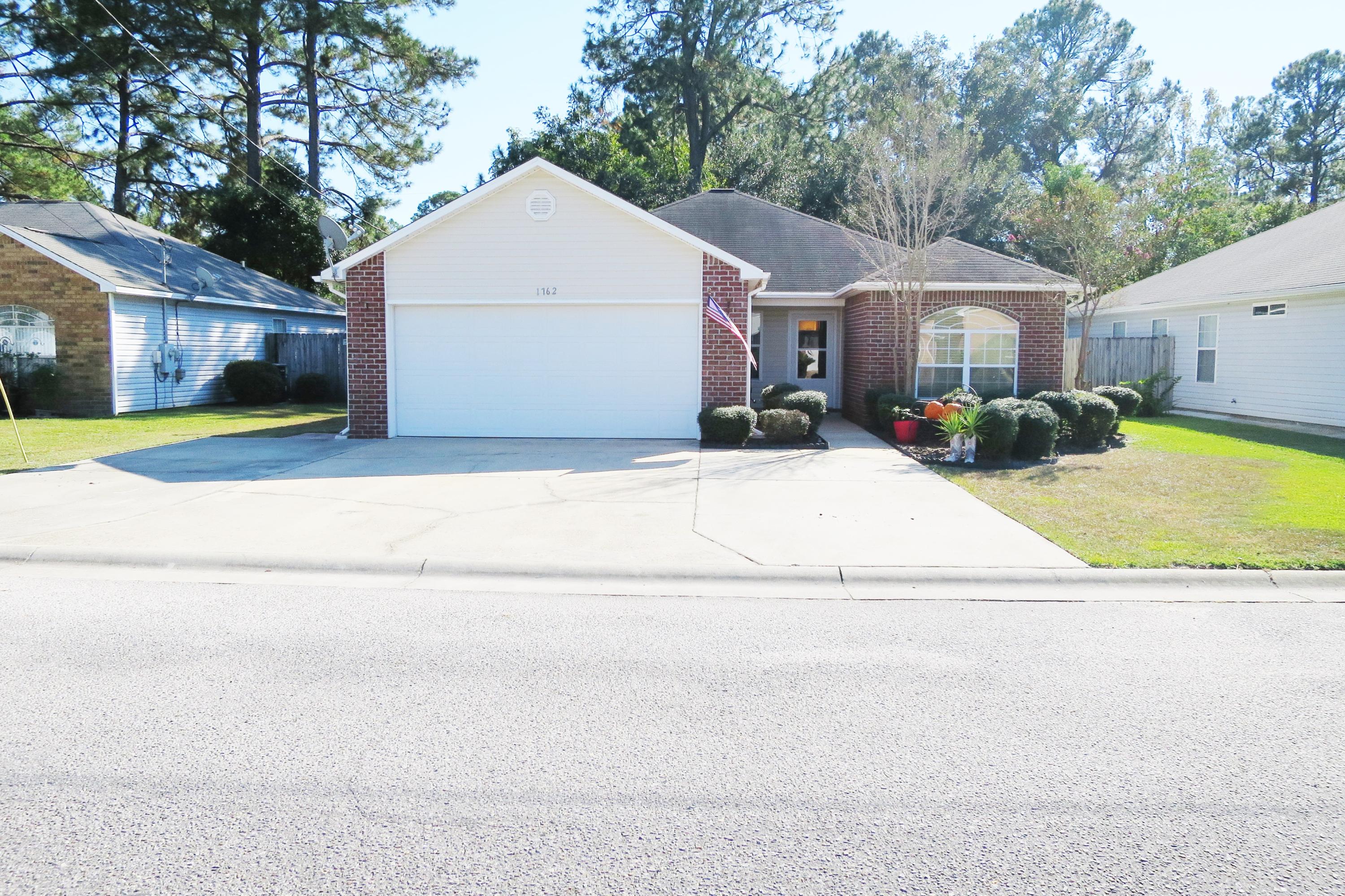 1762 Old Ranch Road Fort Walton Beach, FL 32547 - Photo 21 of 21 a view of a white house with a yard and large tree