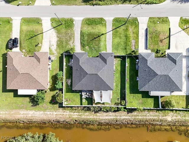 an aerial view of houses with yard