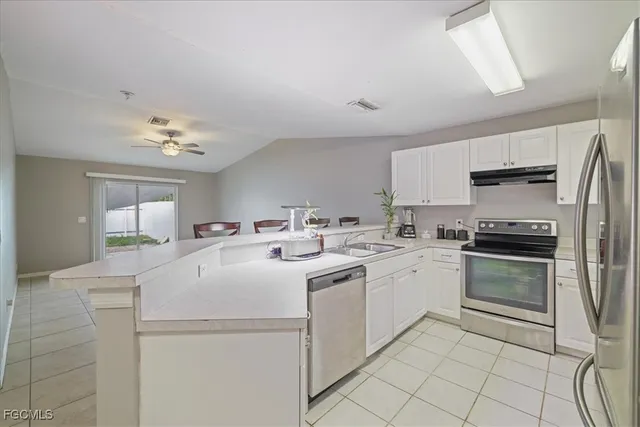 a kitchen with a sink appliances and cabinets