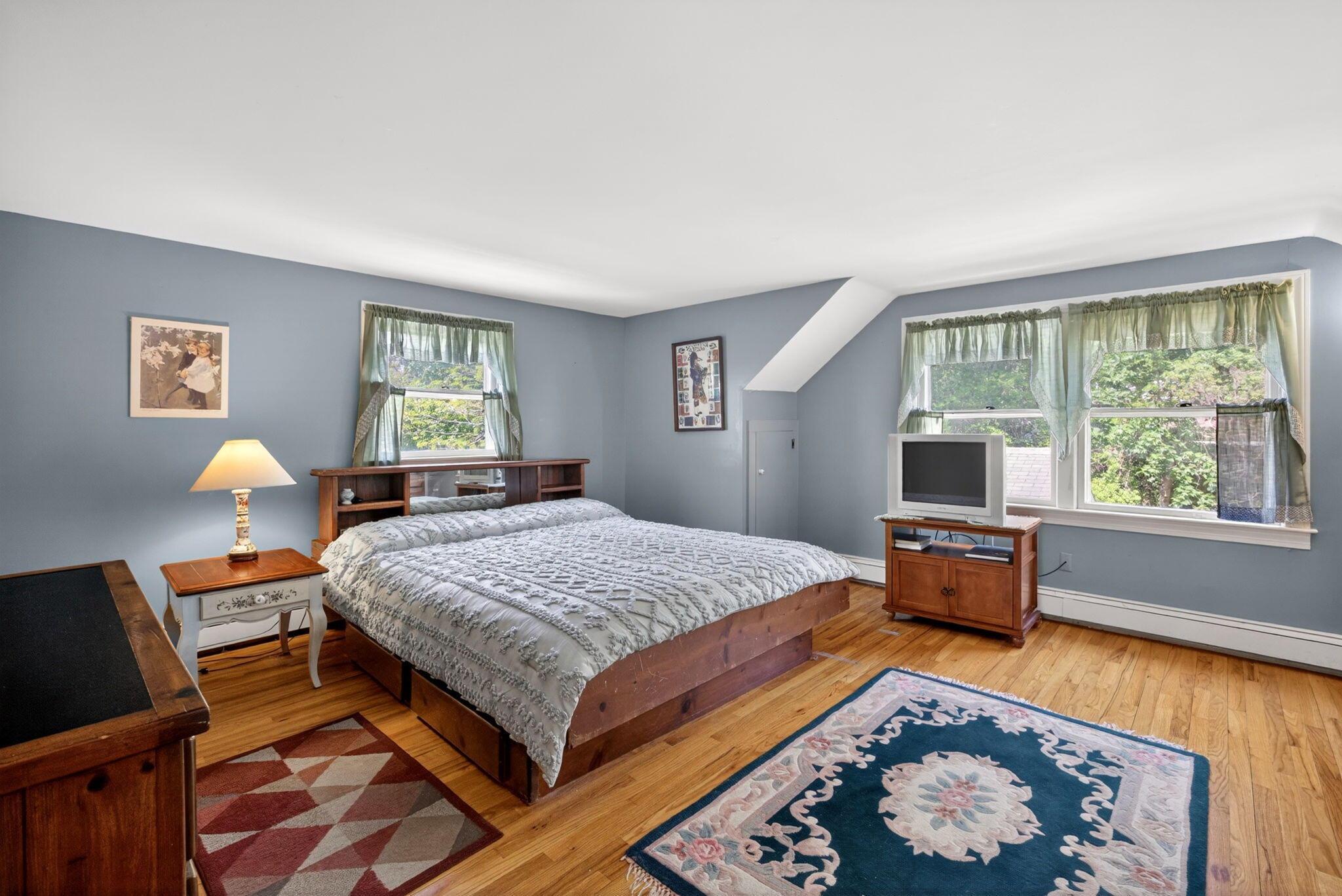 23 Nickerson Road Orleans, MA 02653 - Photo 19 of 54 a bedroom with a bed and wooden floor
