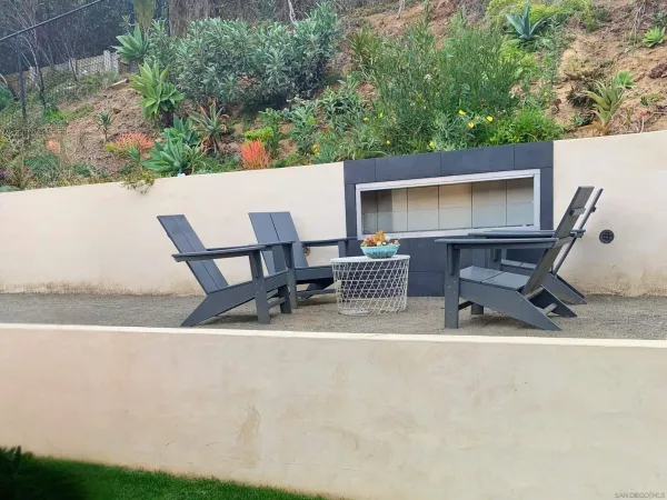 a backyard of a house with table and chairs